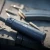 Tłumik Gomander TACTINOX QD-LOCK L 5.56 mm na stole obok magazynka z amunicją.
